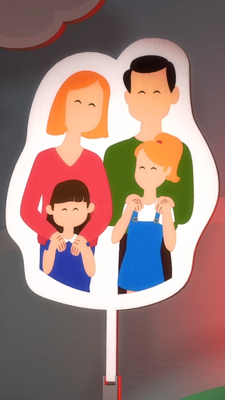 An animated plackard shows a graphic representing a family on top of a colourful background.