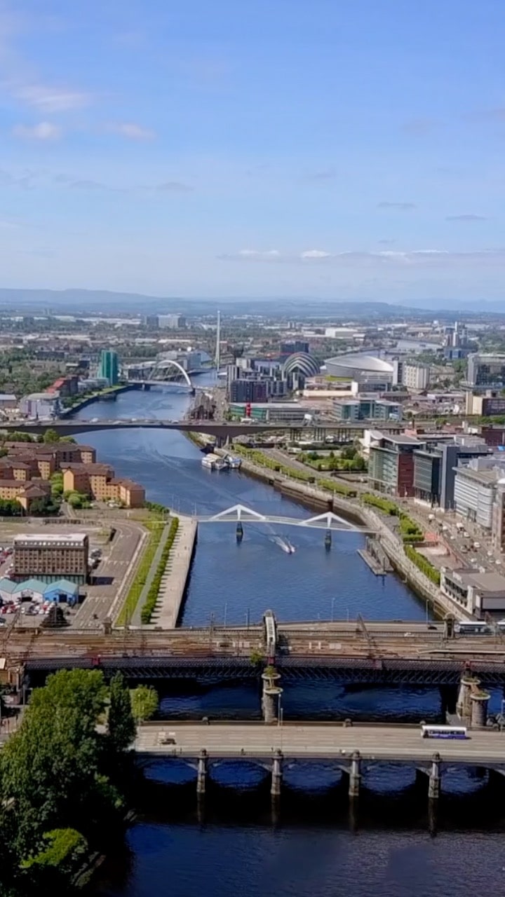 An image of the Glasgow skyline. There is a river in the middle with 5 bridges all passing over it - cars and buildings on either side